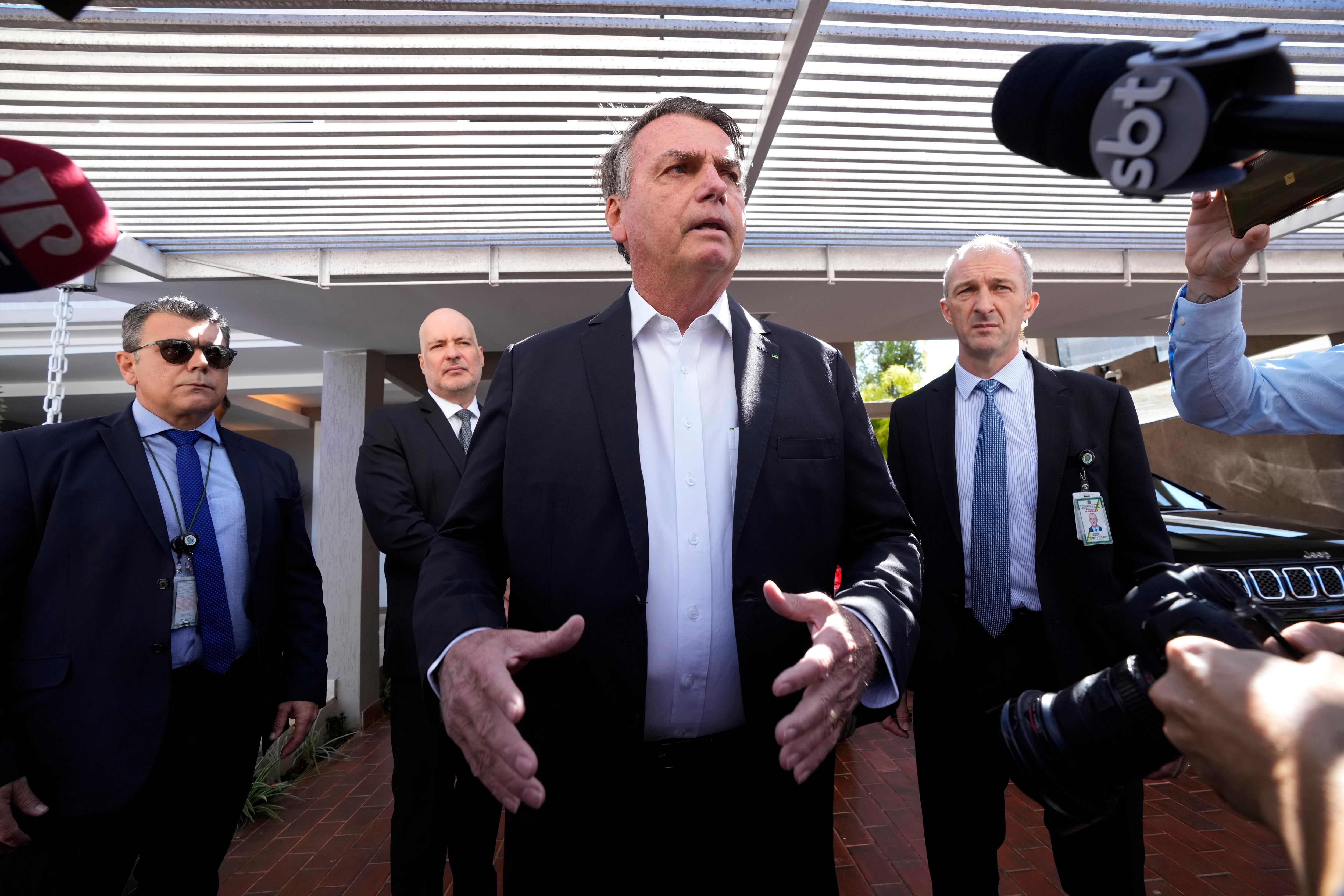 Former Brazilian President Jair Bolsonaro speaks to the press outside his home after Federal Police agents carried out a search and seizure warrant in Brasília, Brazil, on May 3, 2023.