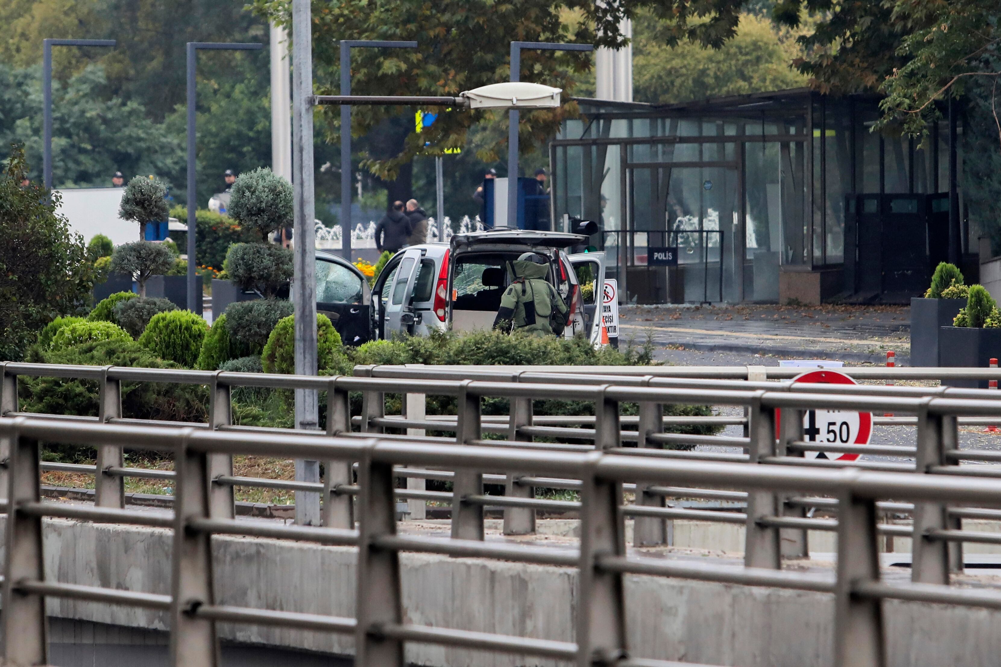 Turkish policemen and security forces cordon off an area next to a car after an explosion in Ankara, Sunday, Oct. 1, 2023. A suicide bomber detonated an explosive device in the heart of the Turkish capital, Ankara, on Sunday, hours before parliament was scheduled to reopen after a summer recess. A second assailant was killed in a shootout with police. (Yavuz Ozden/Dia Images via AP)