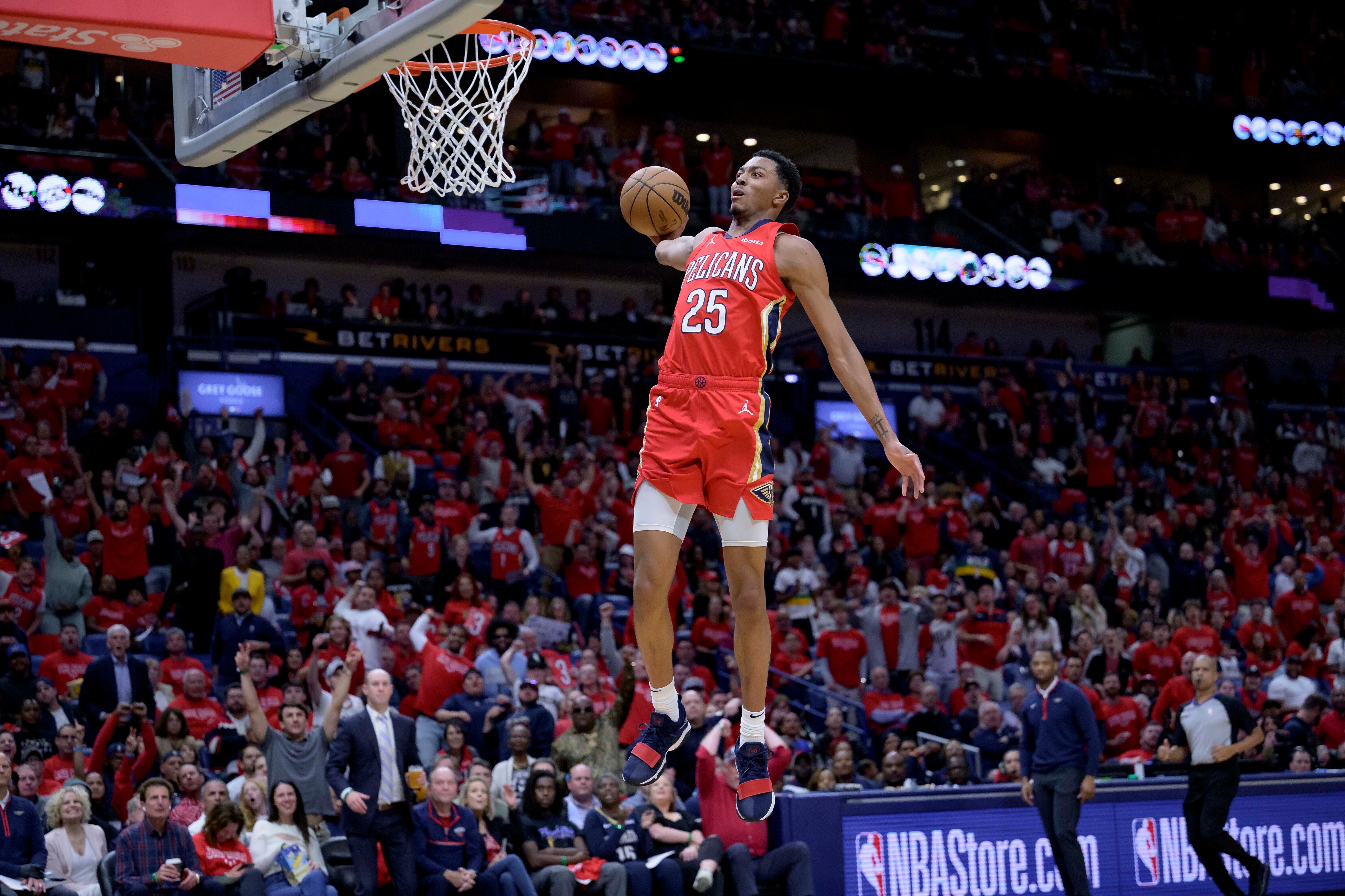 New Orleans Pelicans guard Trey Murphy III (25) breaks free for a dunk during the first half of an NBA basketball play-in tournament game against the Oklahoma City Thunder in New Orleans, Wednesday, April 12, 2023.