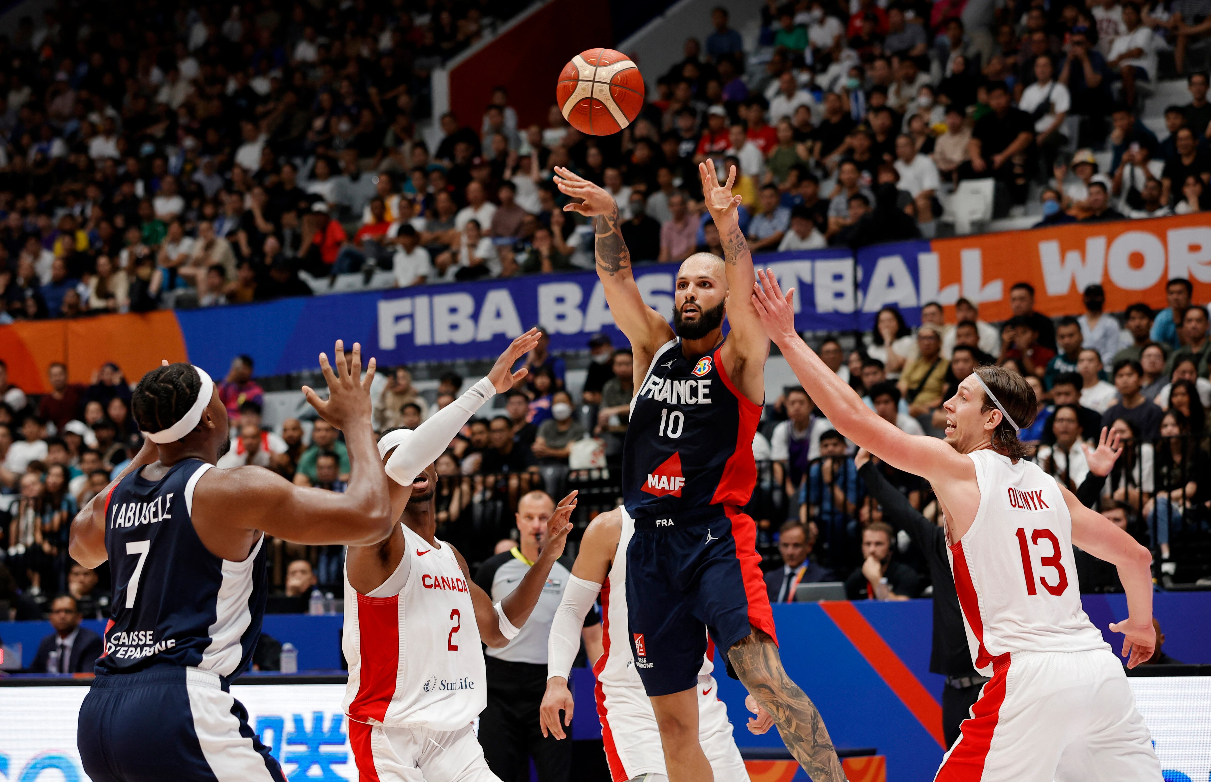 France's Evan Fournier in action with Canada's Kelly Olynyk.