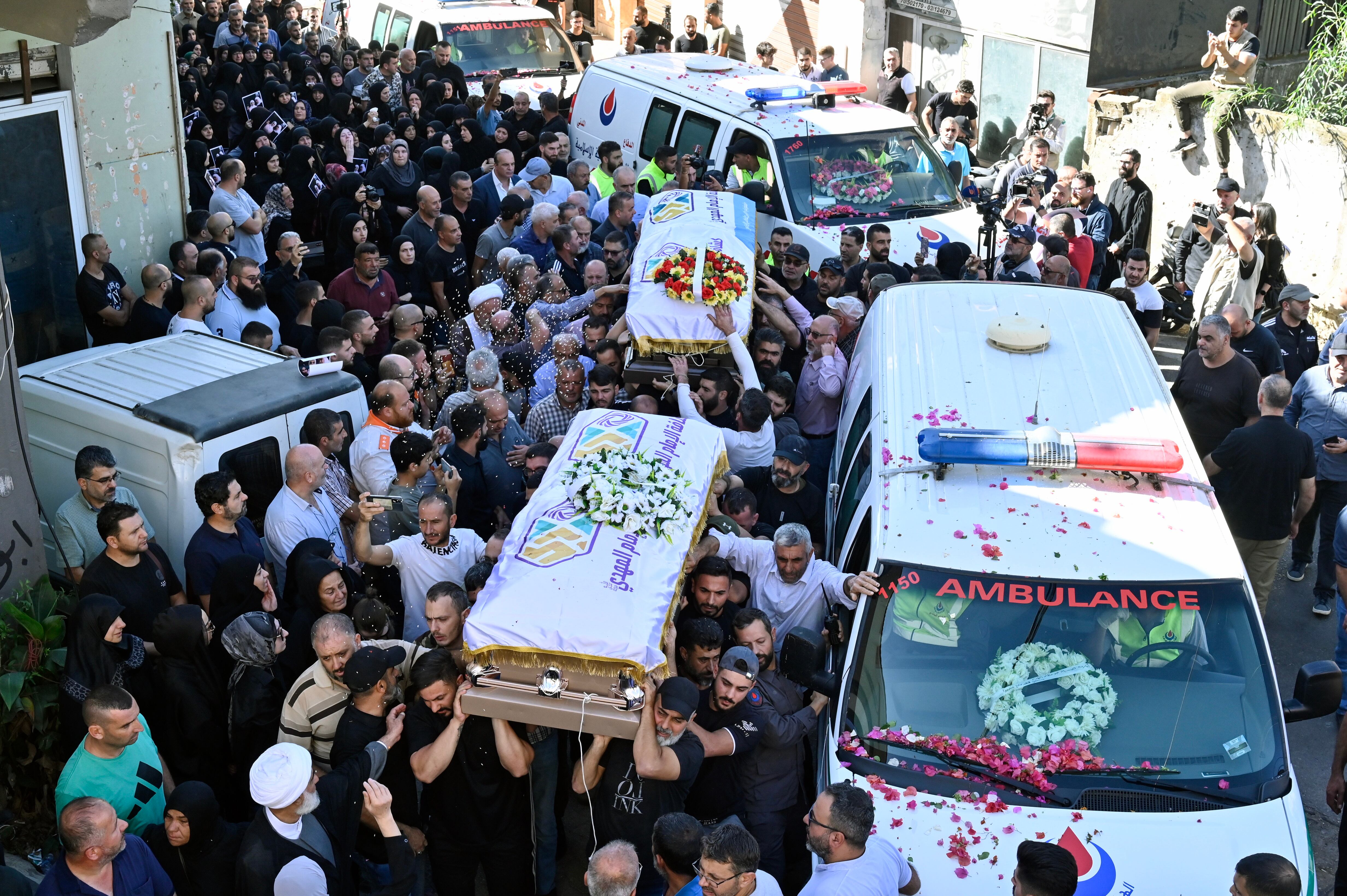 People carry the coffins during the funeral procession for the three children and their grandmother killed in an Israeli airstrike in southern Lebanon, 07 November 2023.
