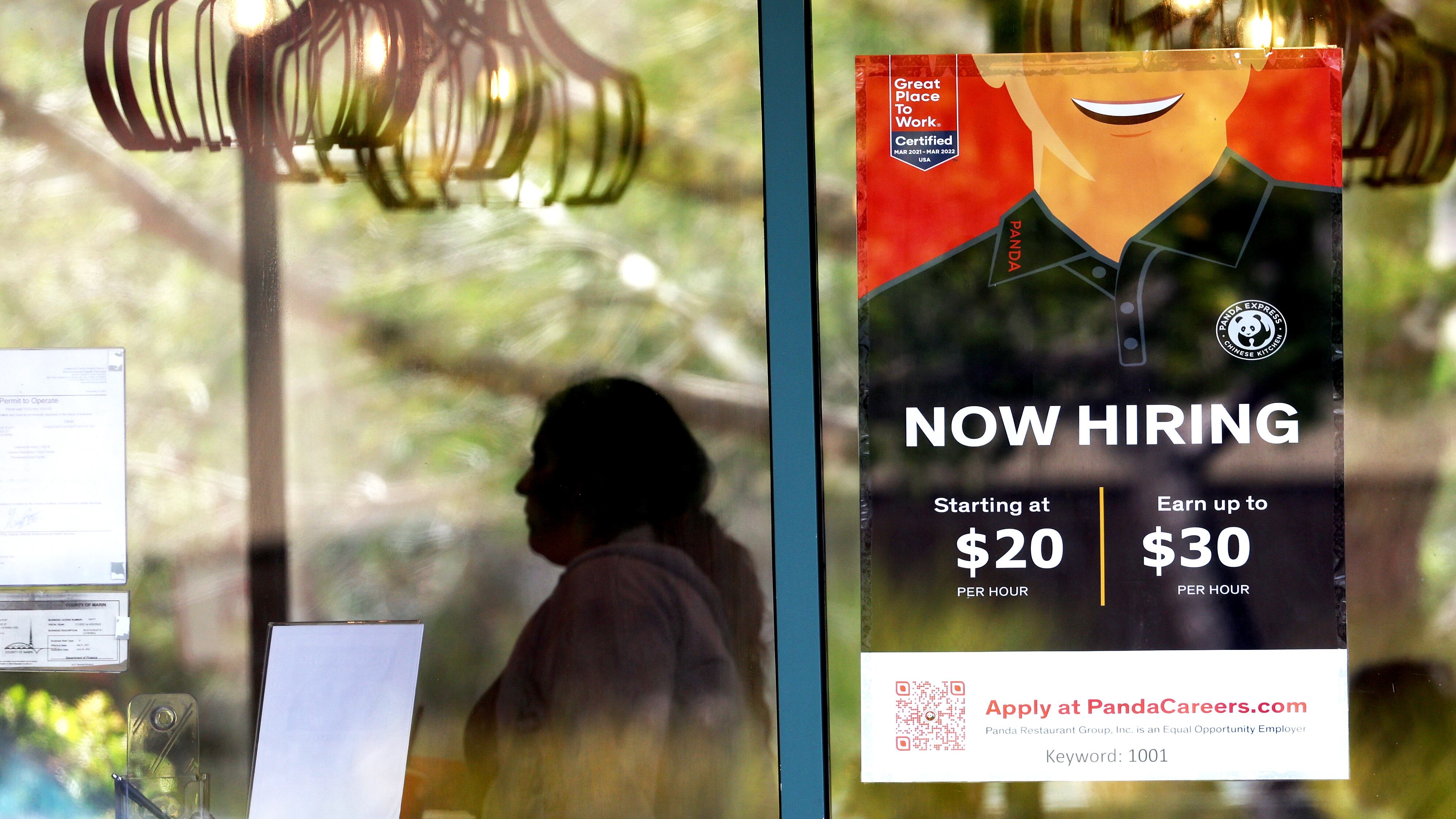 A now hiring sign is posted at a Panda Express restaurant in Marin City, California.