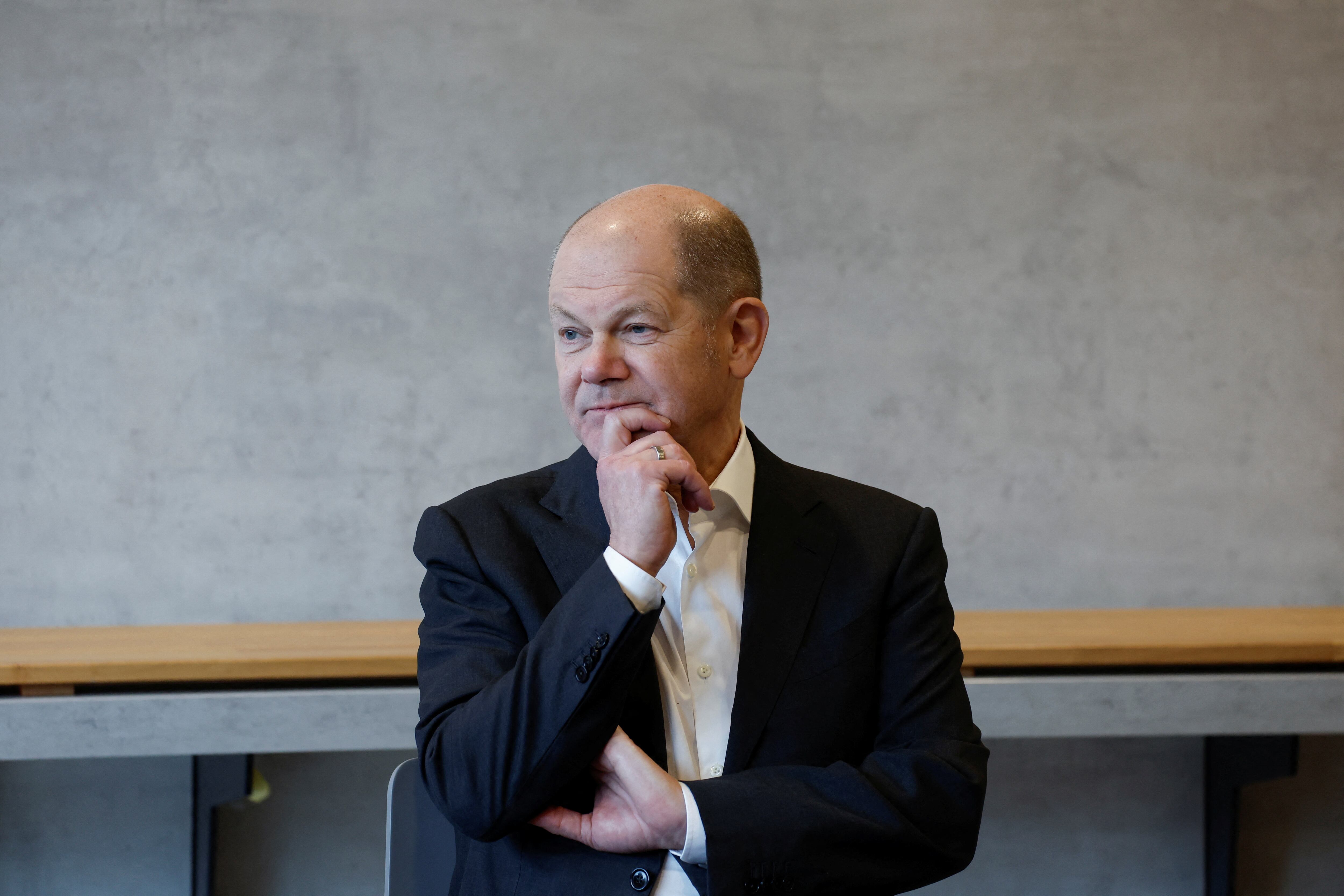 German Chancellor Olaf Scholz engages in a discussion with citizens during a visit to the Europa-Park stadium in Freiburg, Germany, on Tuesday.