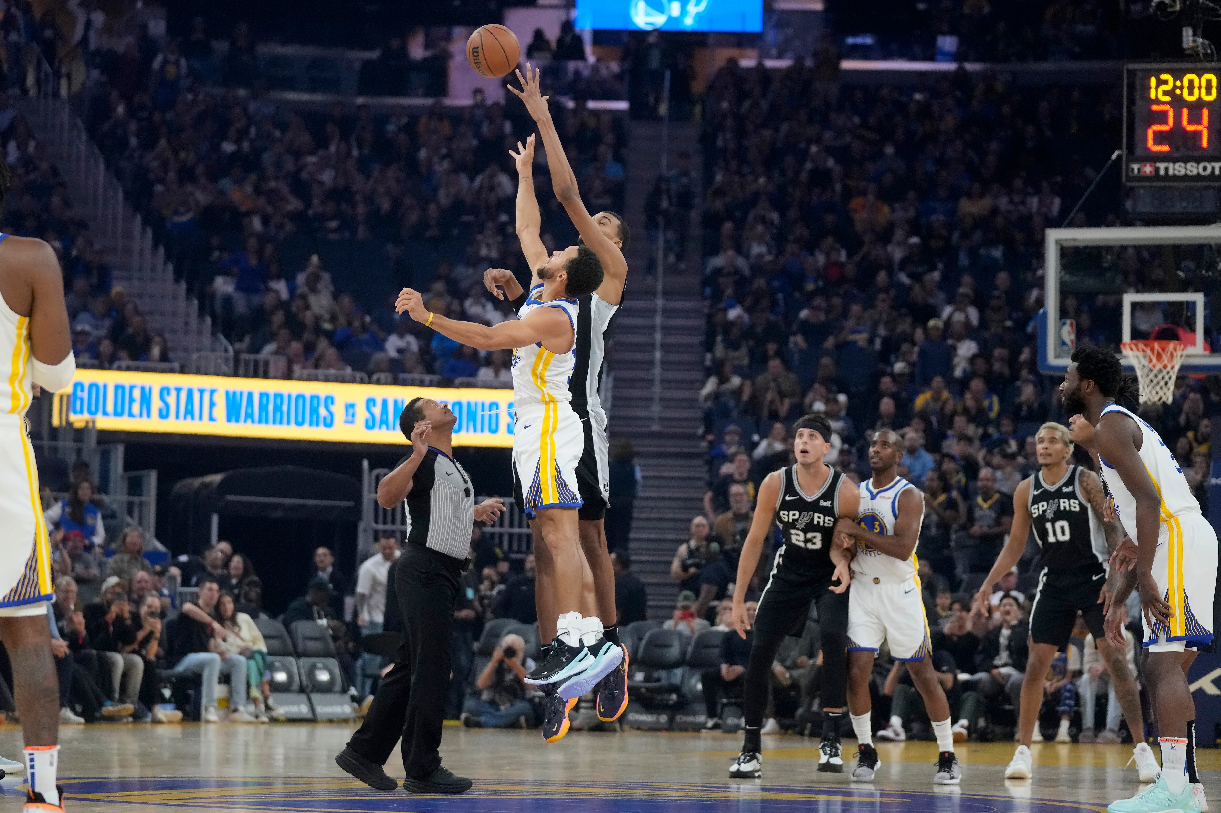 San Antonio Spurs center Victor Wembanyama in the opening jump with Golden State Warriors guard Stephen Curry last Friday.