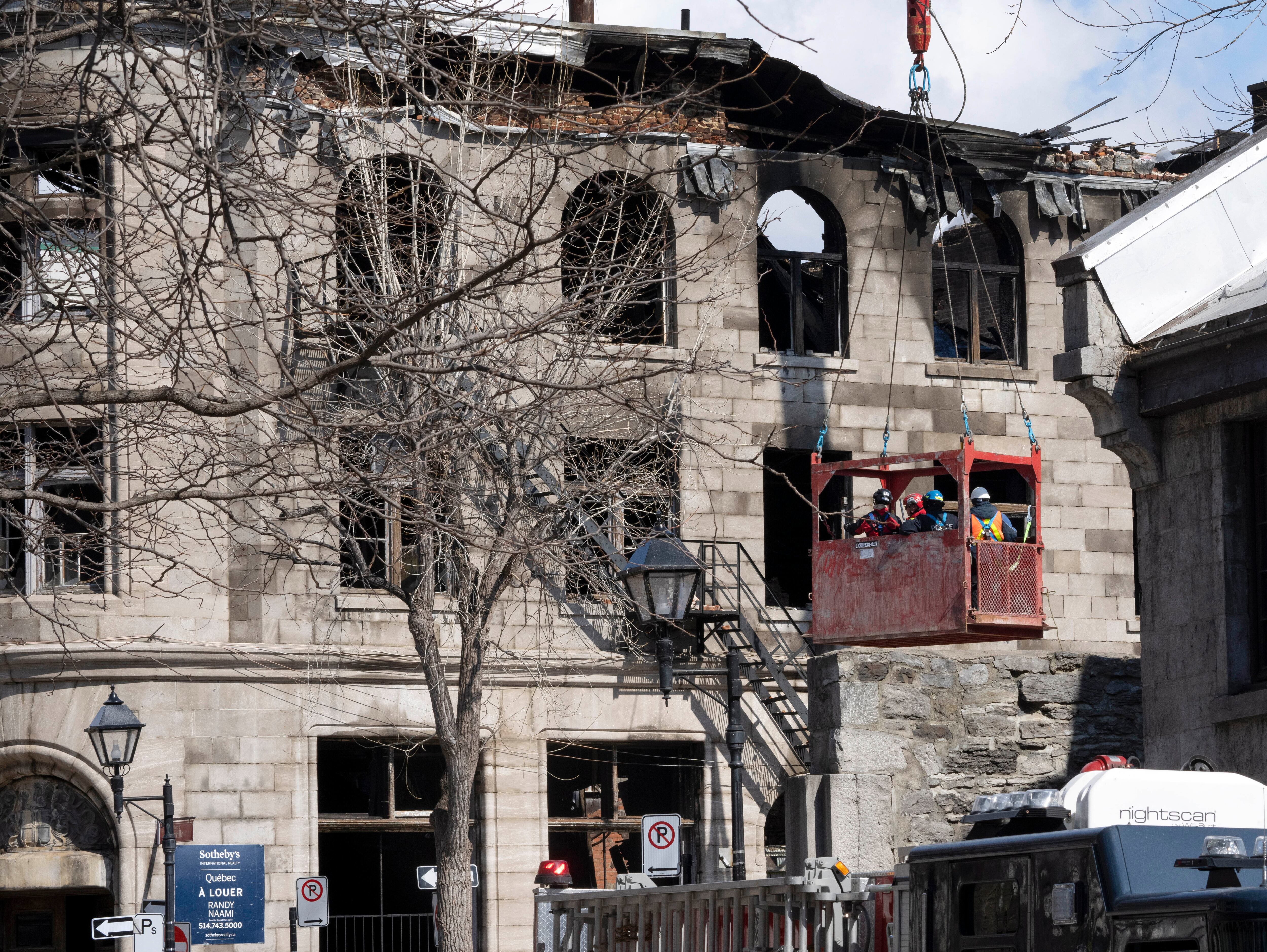 Firefighters continue the search for victims on March 20, 2023 at the scene of last week's fire in Montreal.