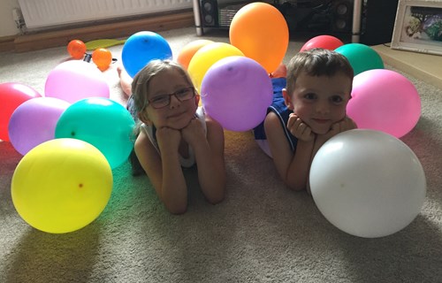 Siblings with balloons