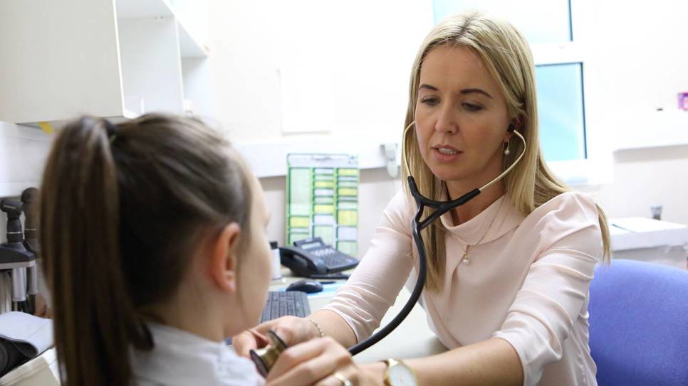 Female GP with child patient