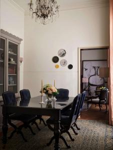 a dining room with a black table and chairs at NoMad London in London