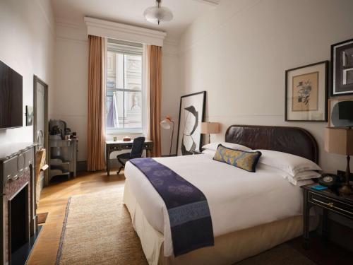 a hotel room with a bed and a desk at NoMad London in London