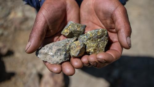 A member of Huancuire community holding copper in hands in Challhuahuacho, Peru