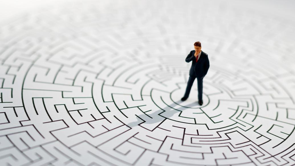 Miniature figure standing in a maze