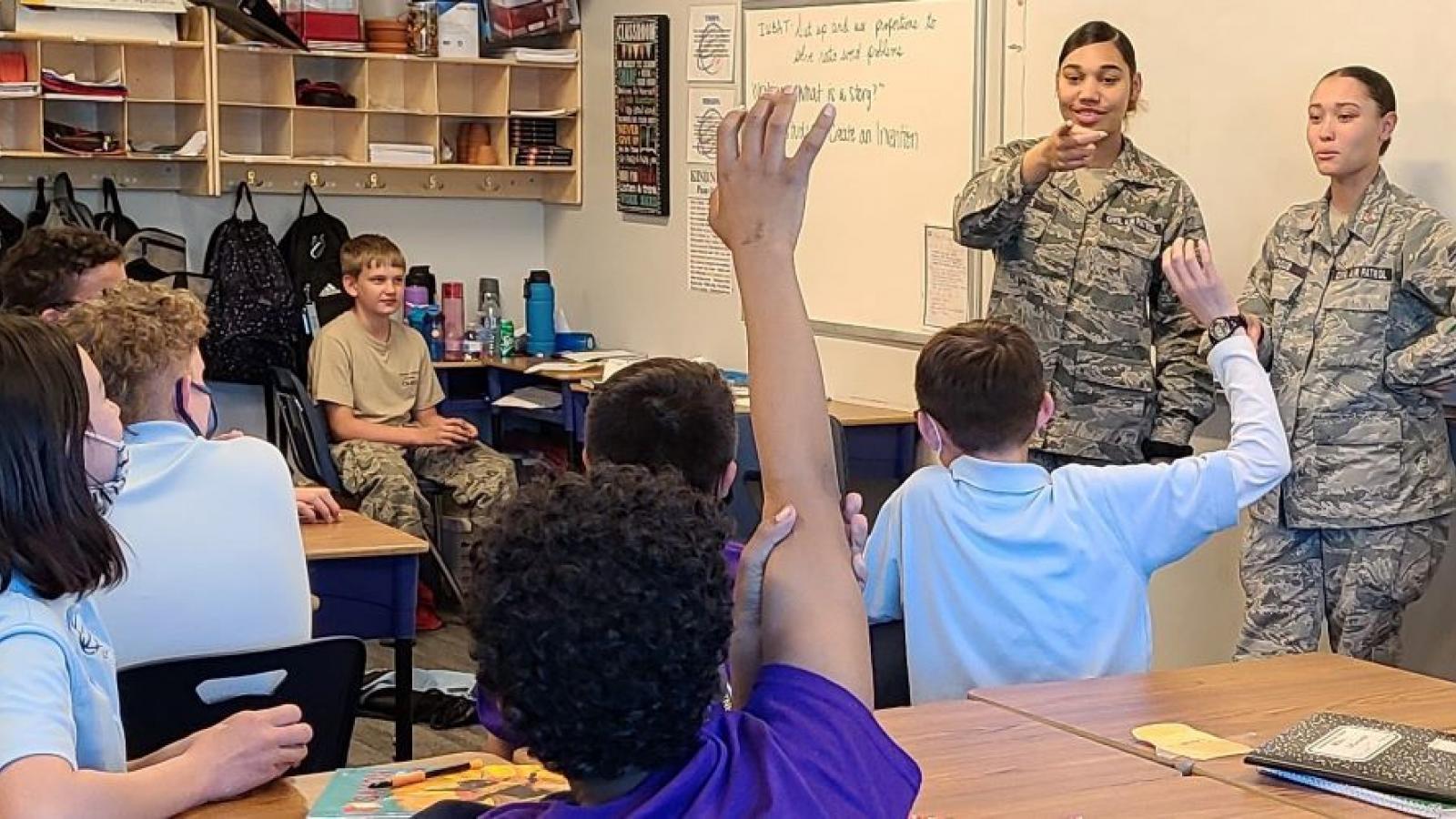 Civial Air Patrol members teaching young children in a classroom