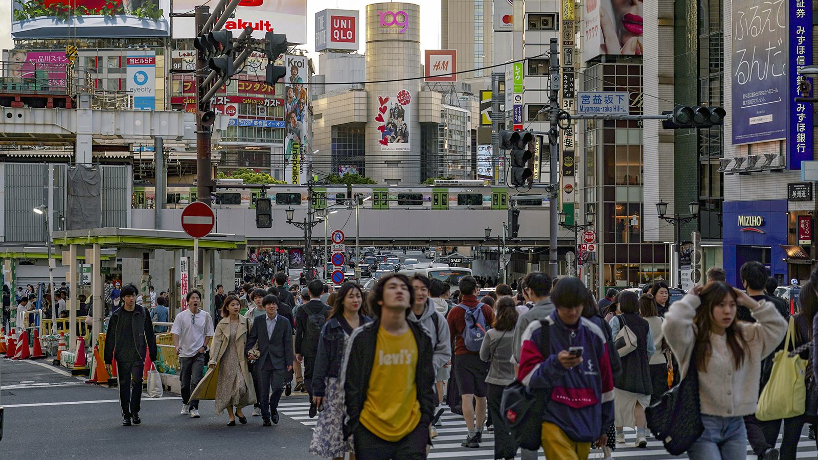 Pedestrians cross an intersection in the Shibuya district of Tokyo, Japan, on Thursday, May 2, 2024.