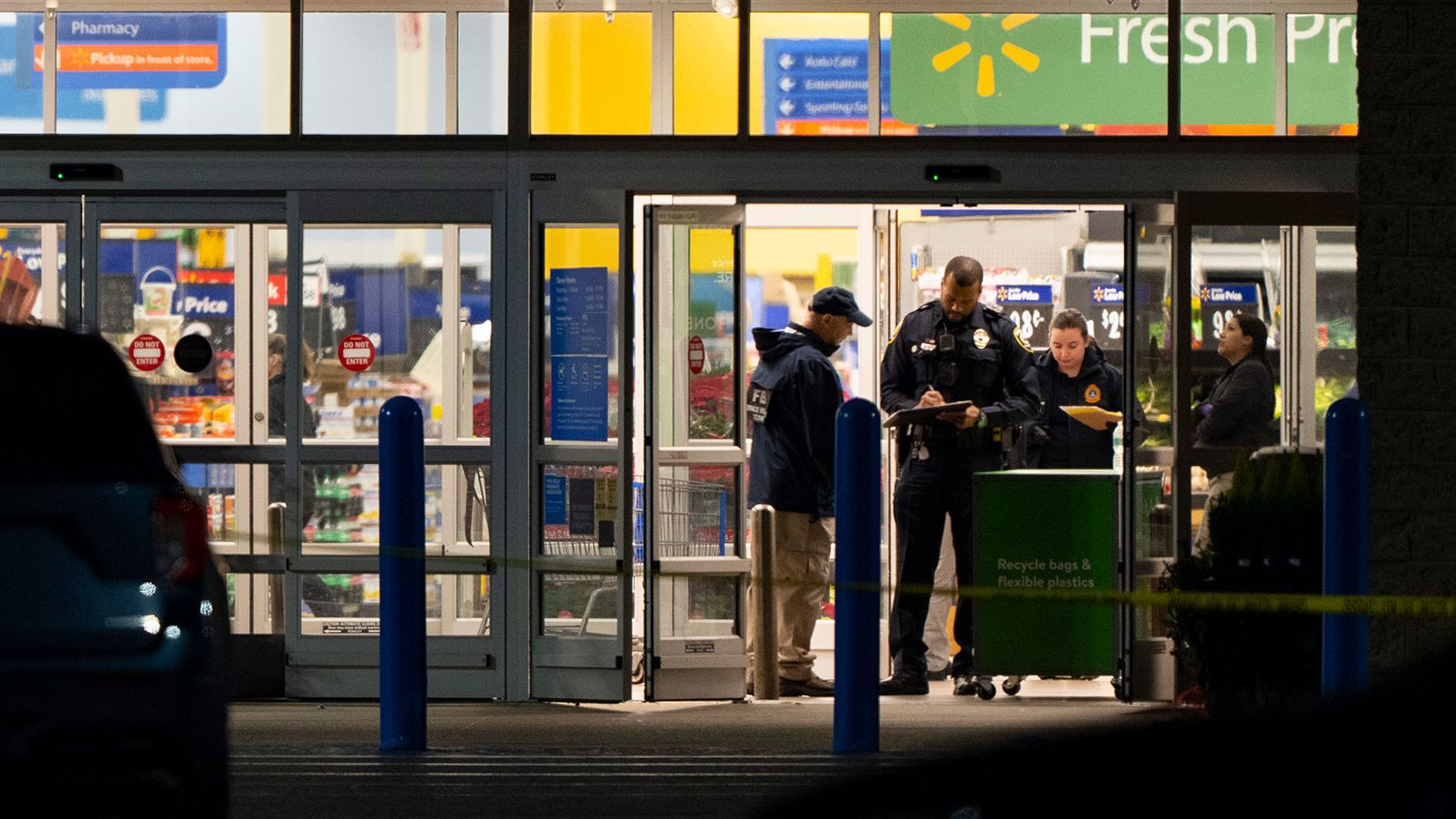 Law enforcement, including the FBI, work at the scene of a mass shooting at a Walmart, Wednesday, Nov. 23, 2022, in Chesapeake, Va.