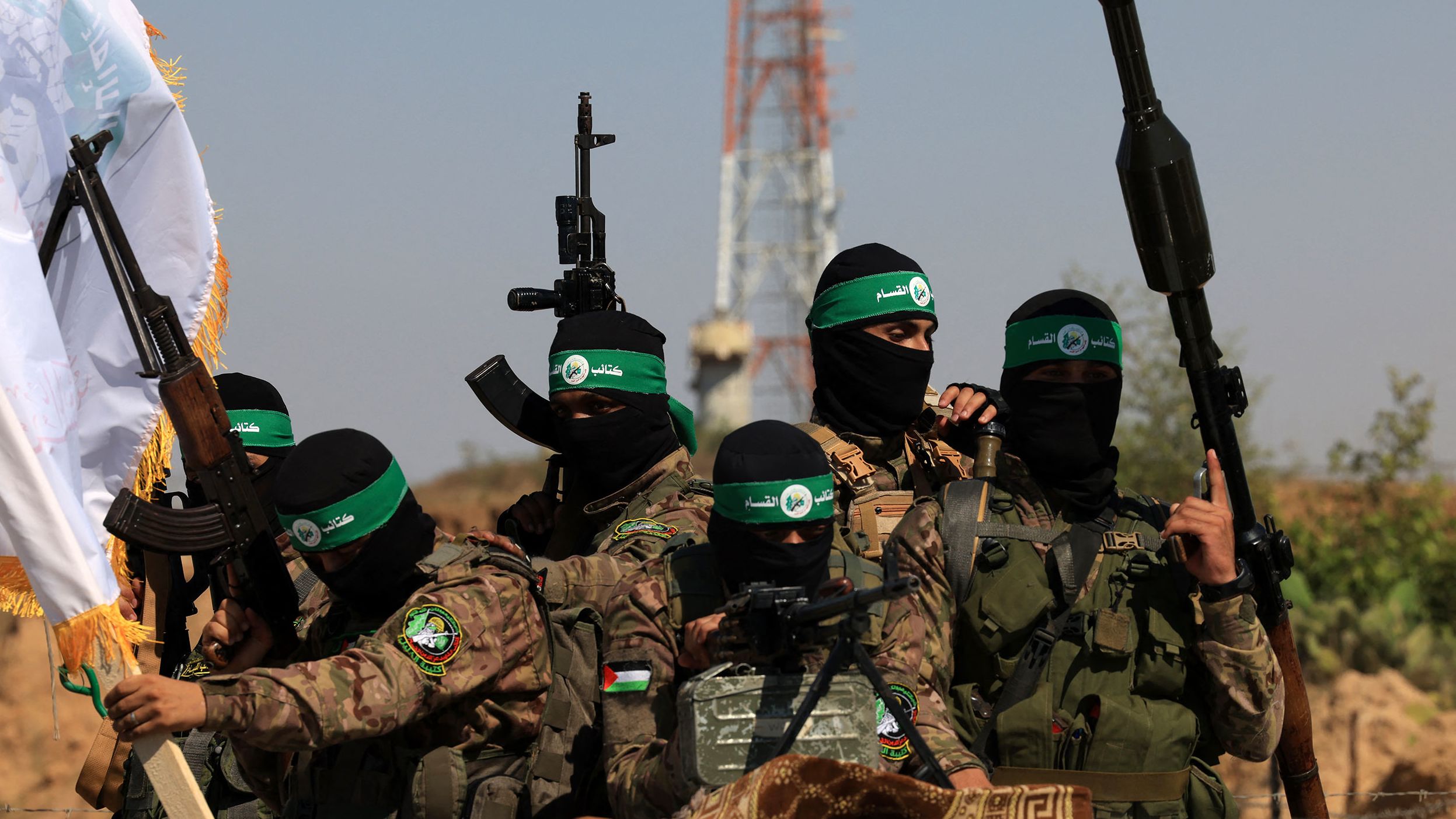 Palestinian fighters of the al-Qassam Brigades, the armed wing of the Hamas movement, take part in a military parade to mark the anniversary of the 2014 war with Israel, near the border in the central Gaza Strip on July 19, 2023. 