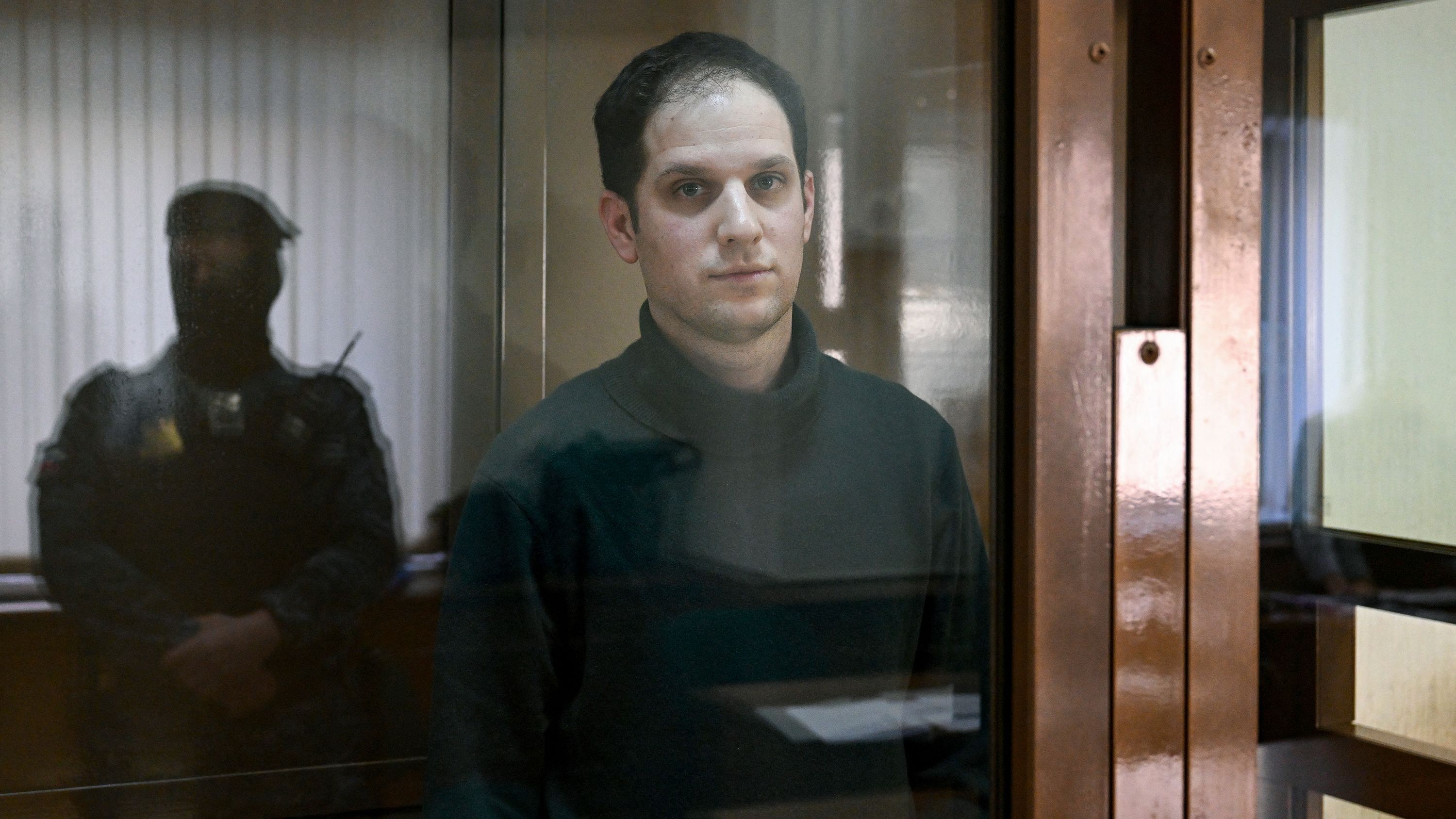 Wall Street Journal reporter Evan Gershkovich looks out from a defendants' box before a hearing at the Moscow City Court in Moscow, Russia on February 20, 2024.