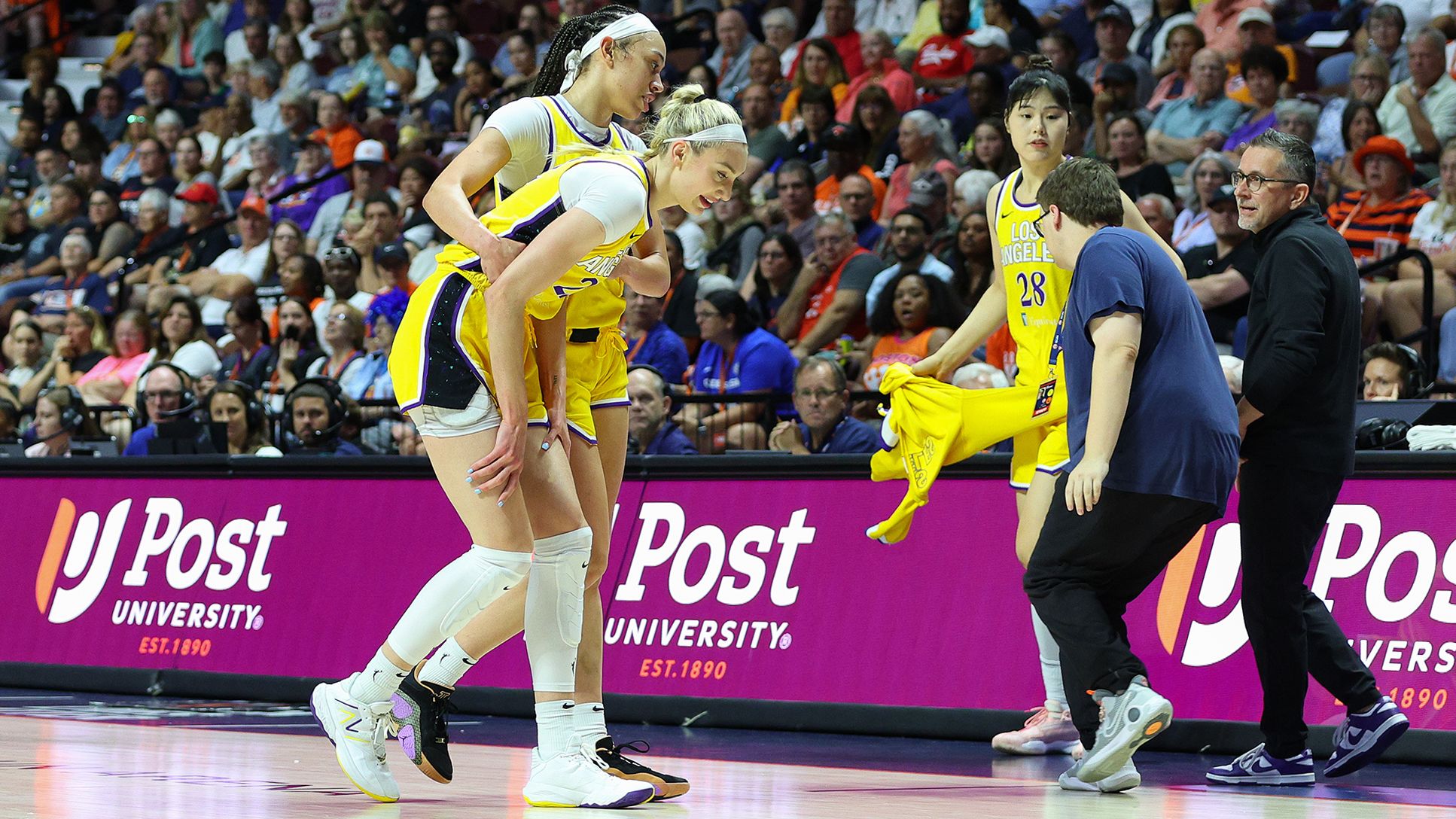 UNCASVILLE, CT - JUNE 18: Los Angeles Sparks forward Cameron Brink (22) sustains an injury and assisted off the court by Los Angeles Sparks forward Dearica Hamby (5) during a WNBA game between Los Angeles Sparks and Connecticut Sun on June 18, 2024, at Mohegan Sun Arena in Uncasville, CT. (Photo by M. Anthony Nesmith/Icon Sportswire via Getty Images)