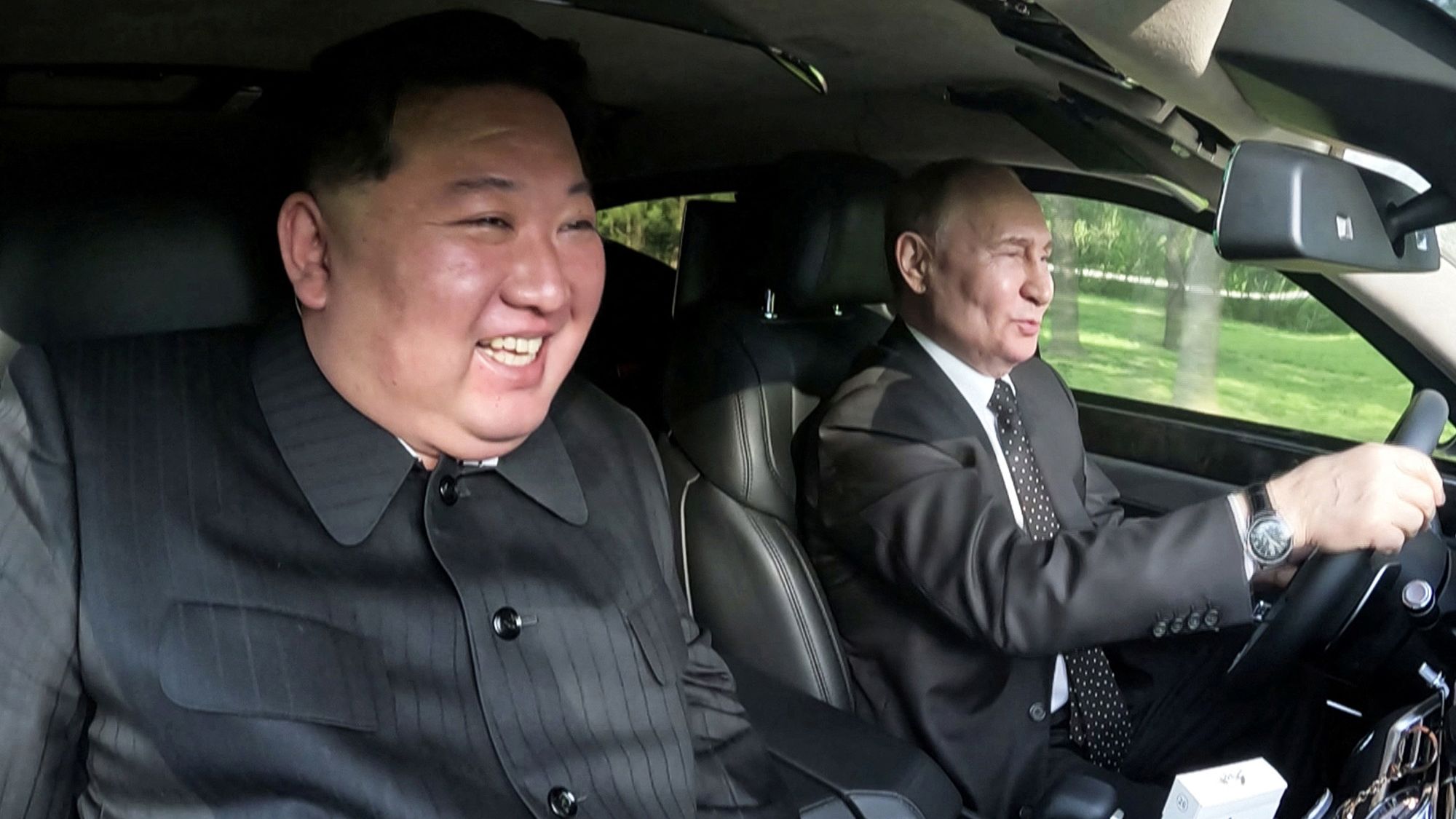 Russia's President Vladimir Putin and North Korea's leader Kim Jong Un ride an Aurus car in Pyongyang, North Korea.