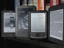 The Kobo eReader Touch, an Amazon Kindle, an Aluratek Libre Air, and a Barnes & Noble Nook, left to right, are displayed.
