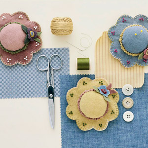 pretty as a pincushion  (APQ June 2005) pincushion with buttons and sewing tools