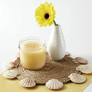 Place mat with shells glued to edge and flower vase