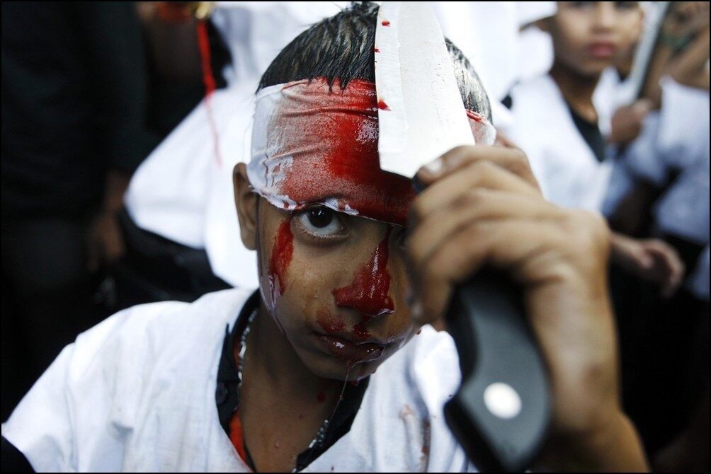 A Muslim boy cuts himself with a knife during a Muharram procession to mark Ashura in Mumbai