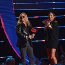 Vince Neil and Sara Evans present an award onstage at the 2014 CMT Music Awards at Bridgestone Arena on June 4, 2014 in Nashville, Tennessee - 395 x 594