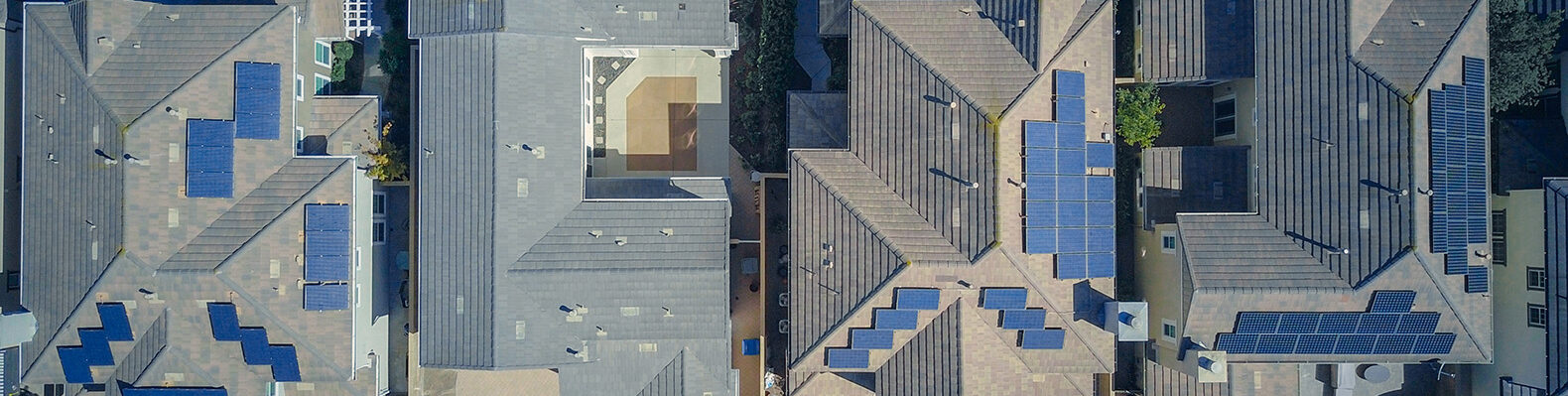 The roof of a neighborhood with solar panels on them