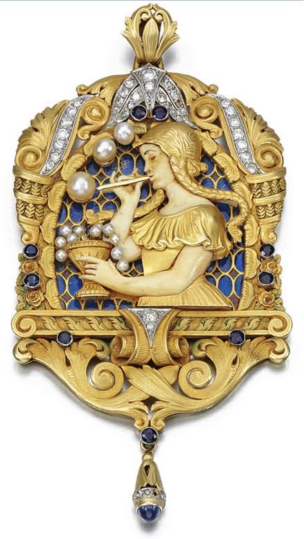 EM-SET PENDANT, FUSET Y GRAU, CIRCA 1920. Depicting a girl blowing pearl bubbles, her arms and face of carved ivory, to a red and blue plique-à-jour enamel background, within a chased surround of acanthus leaves and scrolls highlighted with circular-cut sapphires and similarly and single-cut diamonds, signed Fuset Y Grau.