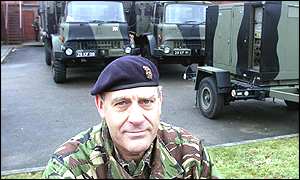 Brigadier Birtwistle in front of army vehicles