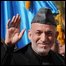 Afghan President Hamid Karzai (2nd L) passes an honour guard as he arrives for his swearing in ceremony as the country"s president for another five years at the Presidential Palace in Kabul on November 19, 2009.