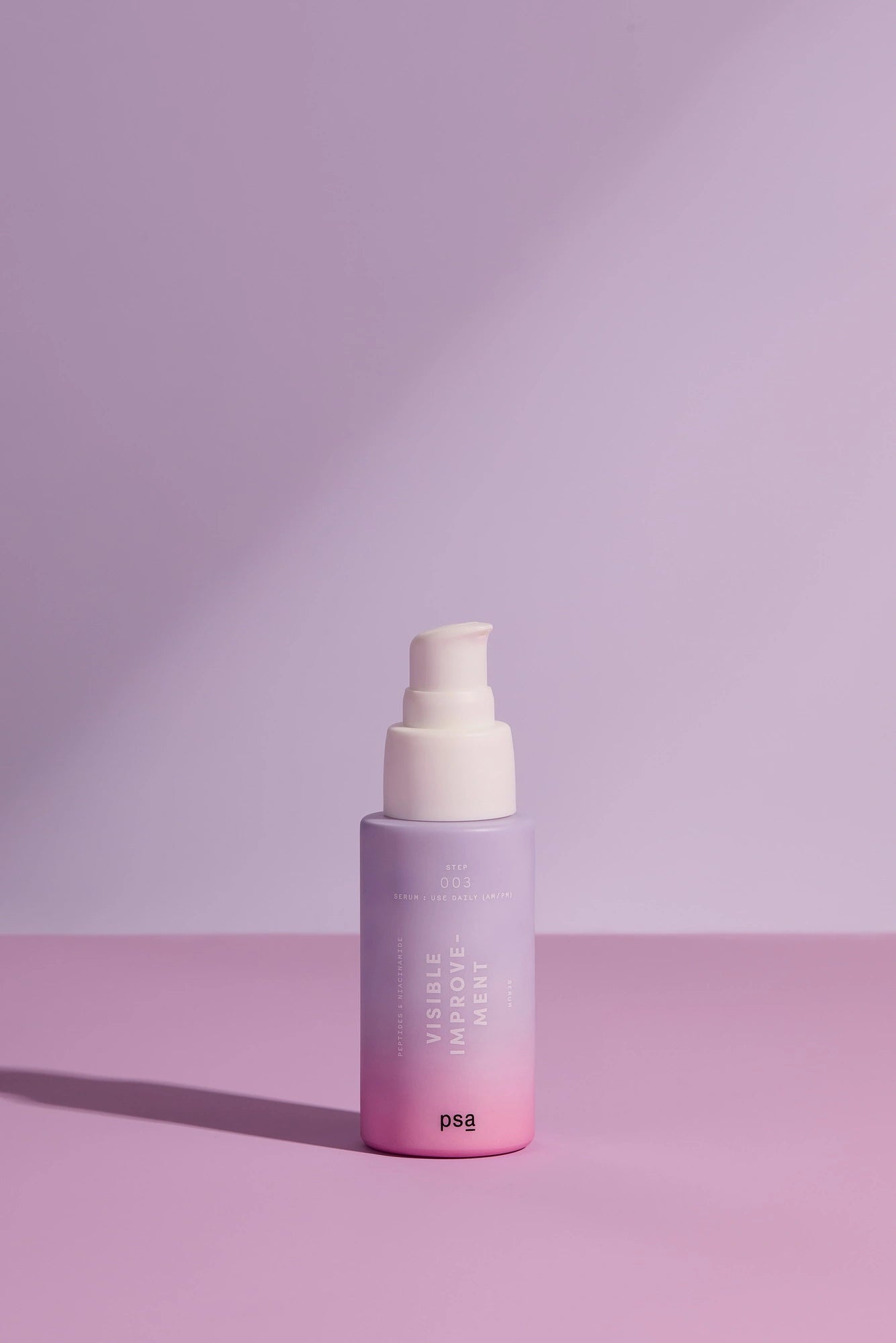 PSA Visible Improvement Peptides & Niacinamide Serum against a purple background