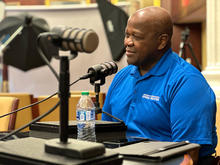 Everett McCorvey sitting in a podcast recording studio