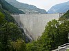 A tall concrete structure in a cold location impedes the flow of a river and creates a lake.