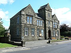 A view of Denny Town House building, with grey brickwork.