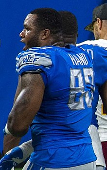 Da'Shawn Hand wearing a Detroit Lions jersey and no helmet, viewed from the side.