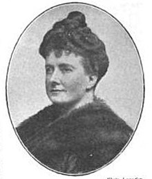 Head and shoulders of a woman in a dark dress