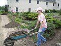 A young guest helps out in the abbey garden