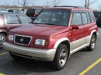 Suzuki Vitara with longer bumpers, wheel arches, side body mouldings, larger grille and powered by V6 engine. This model is known as Escudo V6 in Japan, Sidekick Sport in North America or Vitara V6/TD elsewhere.