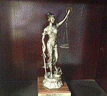 An image of a trophy awarded to a new member of the Order of Barristers. The trophy consists of a statute of Lady Justice.