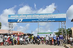 A sign saying "Welcome to Hồng Ngự District"