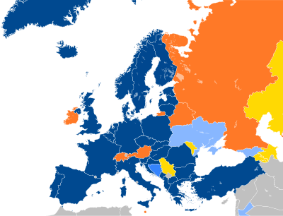 A map of Europe with countries in blue, cyan, orange, and yellow based on their NATO affiliation