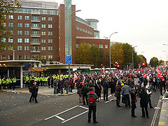 street protesters holding banners, police in presence