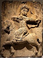 Amir Hasan II (letters ԱՄՐ ՀՍ "AMR HS") hunting on horseback in Mongol attire, Church of the White Virgin (completed 1321). History Museum of Armenia, Yerevan.[31][45]