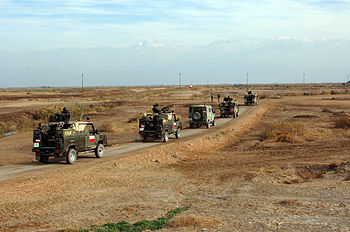 A convoy for the Polish CIMIC group (Civilian Military Cooperation) heads to an elementary school in Ad Diwaniyah, Iraq on January 19, 2005. They are going to deliver school supplies and toys.
