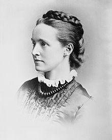 A black and white left profile formal photograph of a woman
