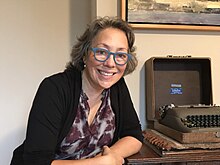 photo of Lise Funderburg in her home office, next to her mother's typewriter