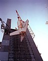 The Space Shuttle Orbiter simulator is hoisted into the Saturn V dynamic test stand in 1977