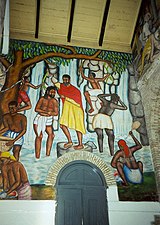 Um mural representando o batismo de Jesus em um típico cenário rural haitiano, Cathédrale de Sainte Trinité, Porto Príncipe, Haiti.