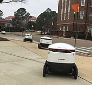 A line of Starship Technologies delivery robots at the University of Mississippi in 2021
